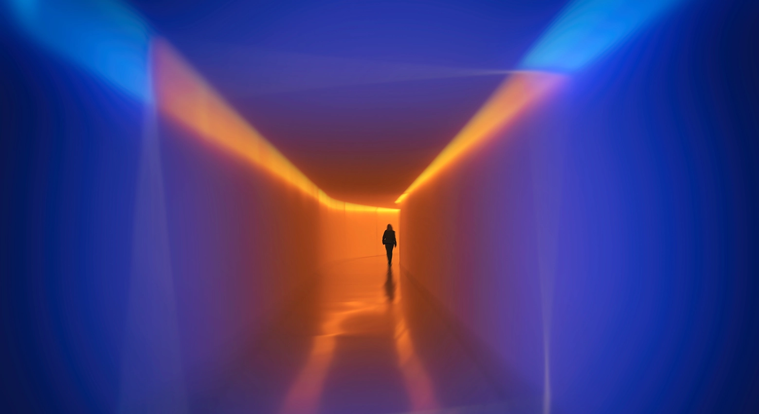 Blue and orange light in room with figure standing 