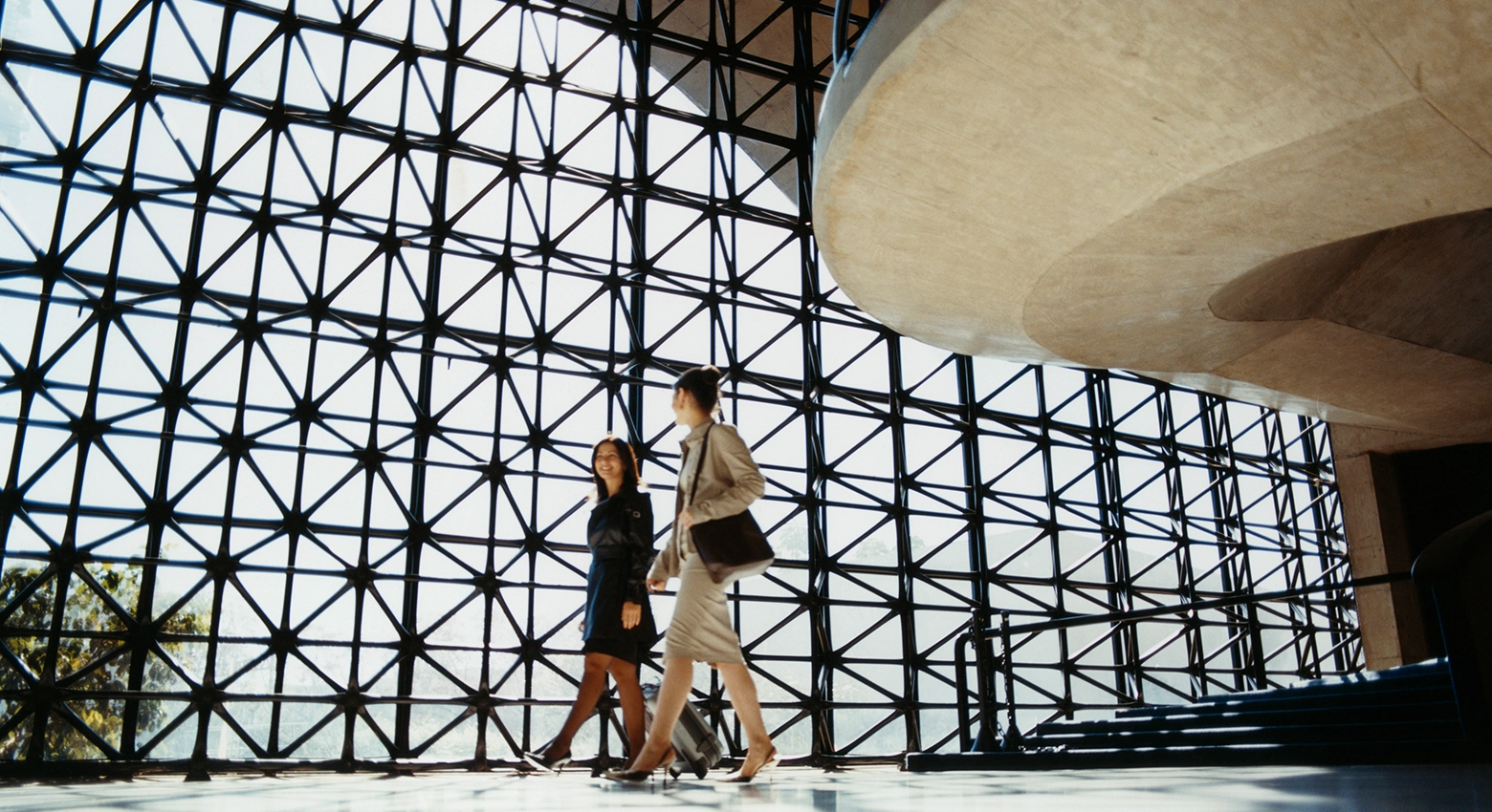 Two women walking in business office 