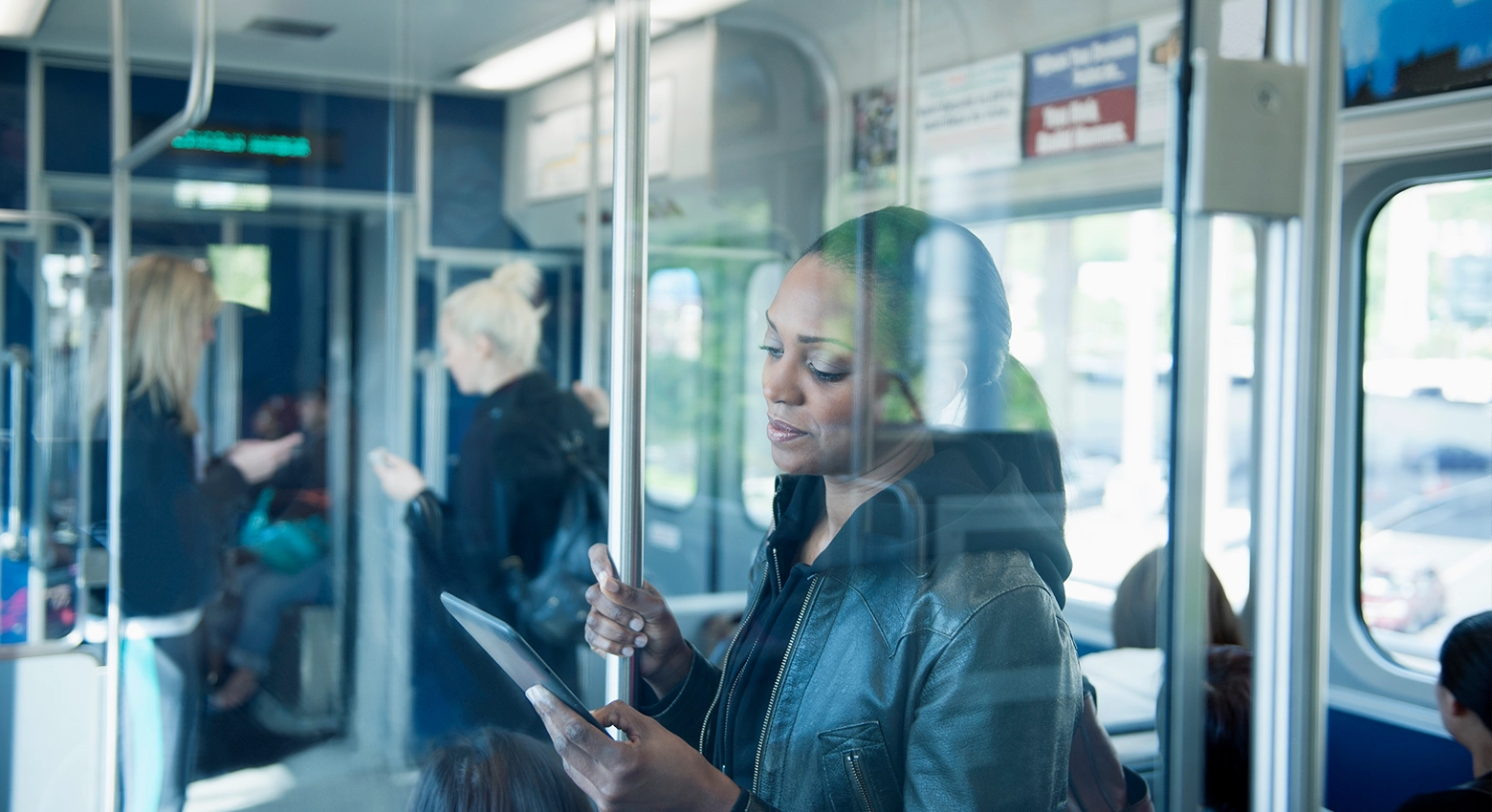 Woman reading tablet on the train 